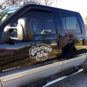 Black pickup truck with "Bittersweet Farm" logo.